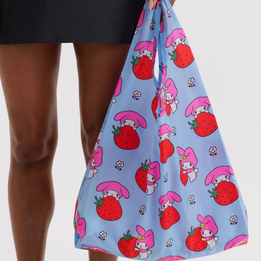Model holding the standard shopping bag