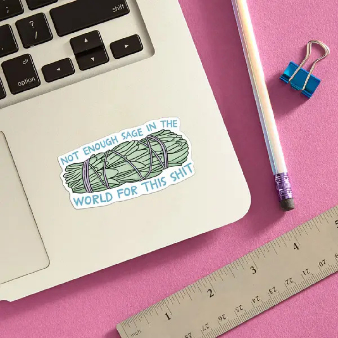 Sage sticker on a laptop with a pencil and ruler to show scale