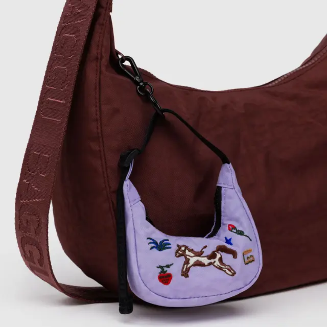 Charm clipped onto a Baggu bag