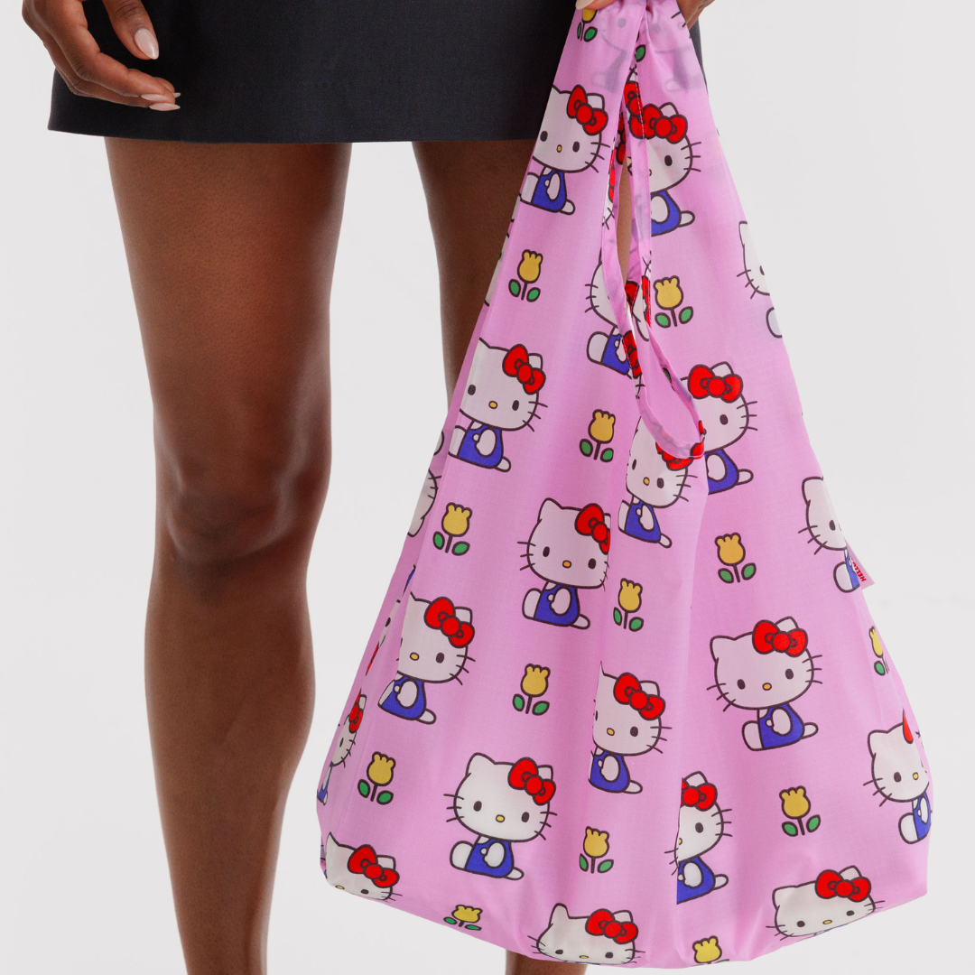 Model holding the standard shopping bag