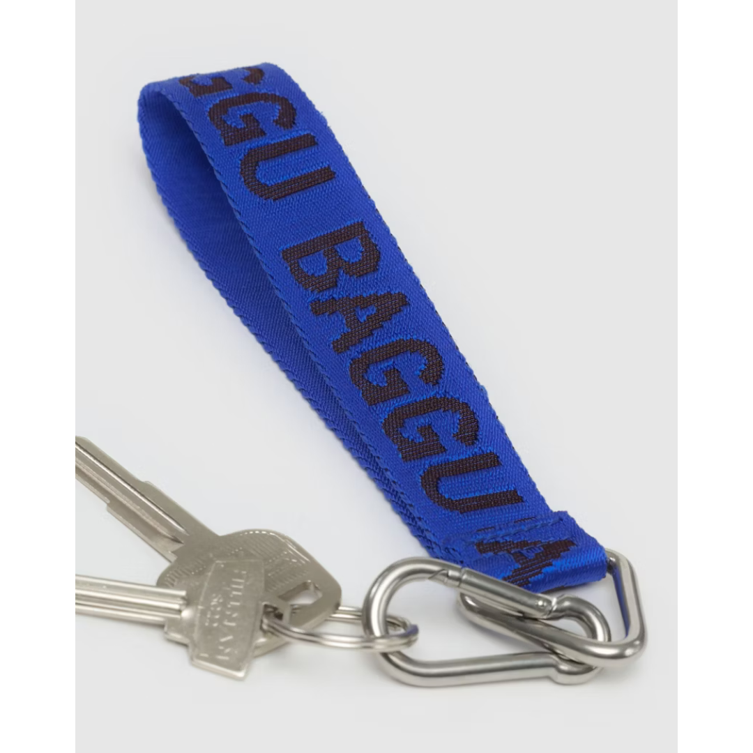 Bright blue lanyard featuring the word "BAGGU" in a darker blue font and a silver keychain and carabiner attached.