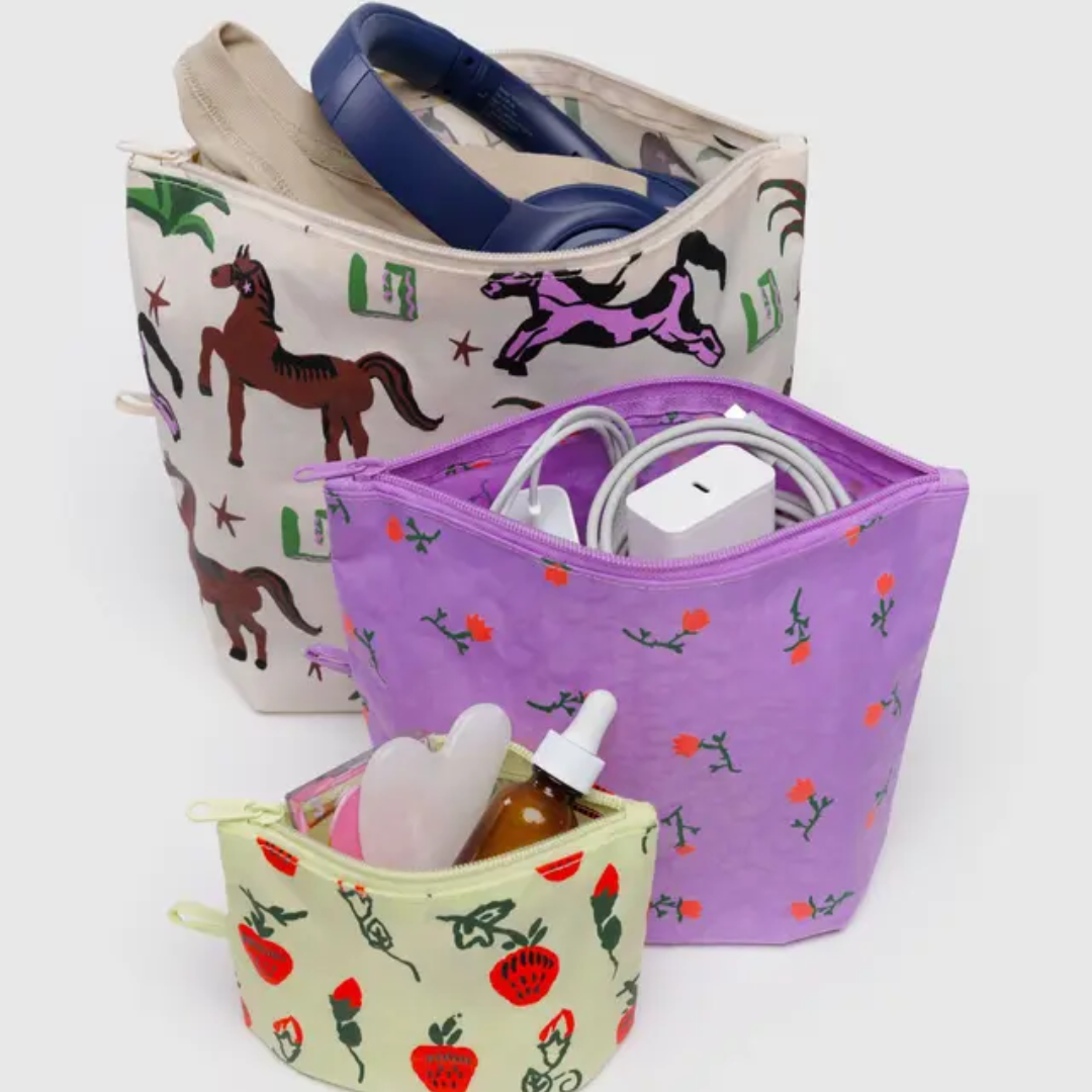 Set of three patterned pouches with items inside