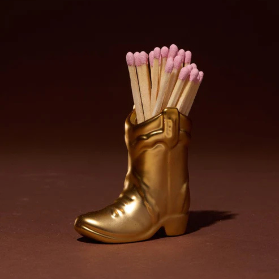 Gold boot-shaped match holder with matches