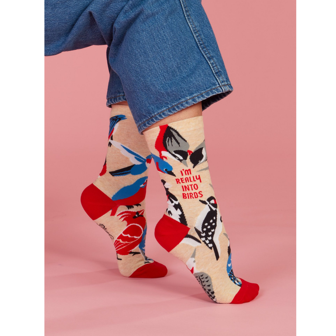 Person wearing "I'm really into birds" socks with jeans