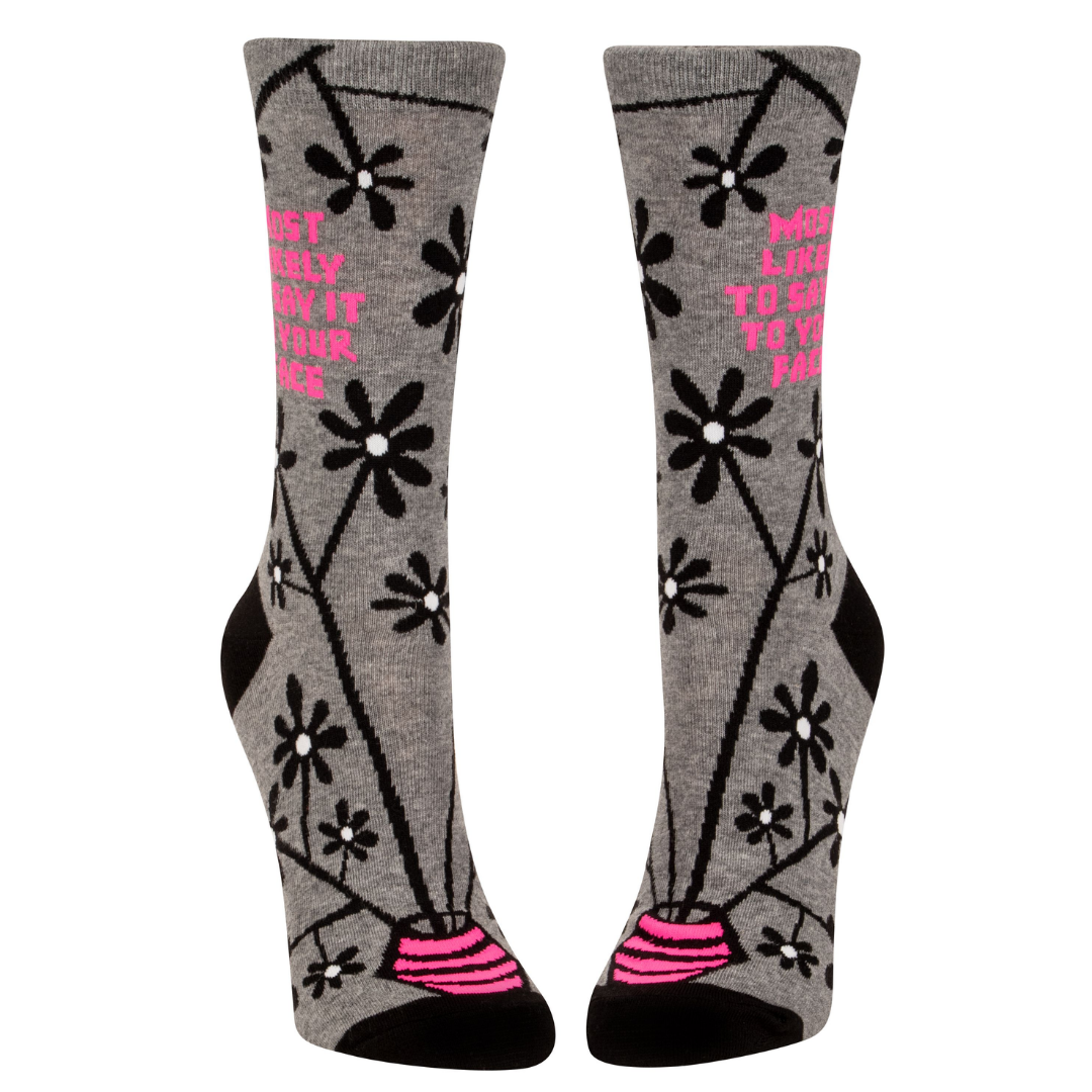 Front view of "Most likely to say it to your face" socks with a bright pink vase at the toe of the socks with black and white flowers