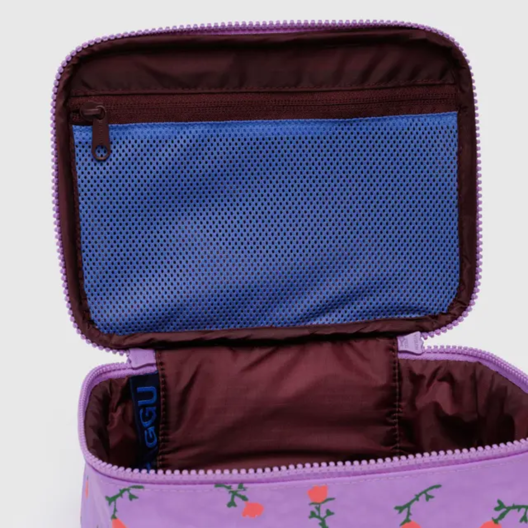 Detail of the interior of the makeup bag featuring a zipped mesh pocket