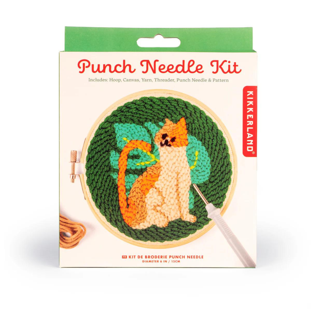 White and green packaging for cat punch needle kit featuring the words "punch needle kit" in red writing.