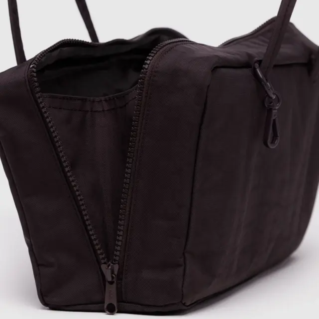 Detail of open bag shows a side gusset inside the zipper to maximize storage.
