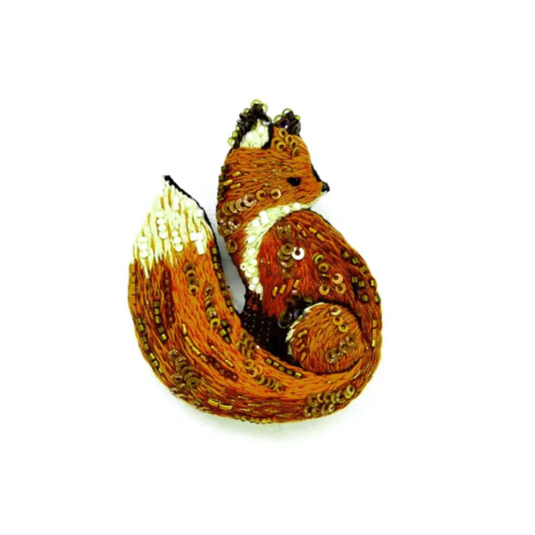 Hand embroidered and beaded fox brooch. This little cutie is adorably embroidered in shades of orange, rust, red, and cream with black accents on his ears, eyes, and nose. His coat is scattered with bronze beads and micro sequins with white beads on his chest, tail, and ears.