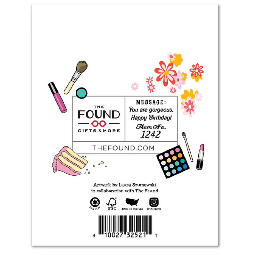 Back of card features illustrations of make-up, cake, and 60's flowers