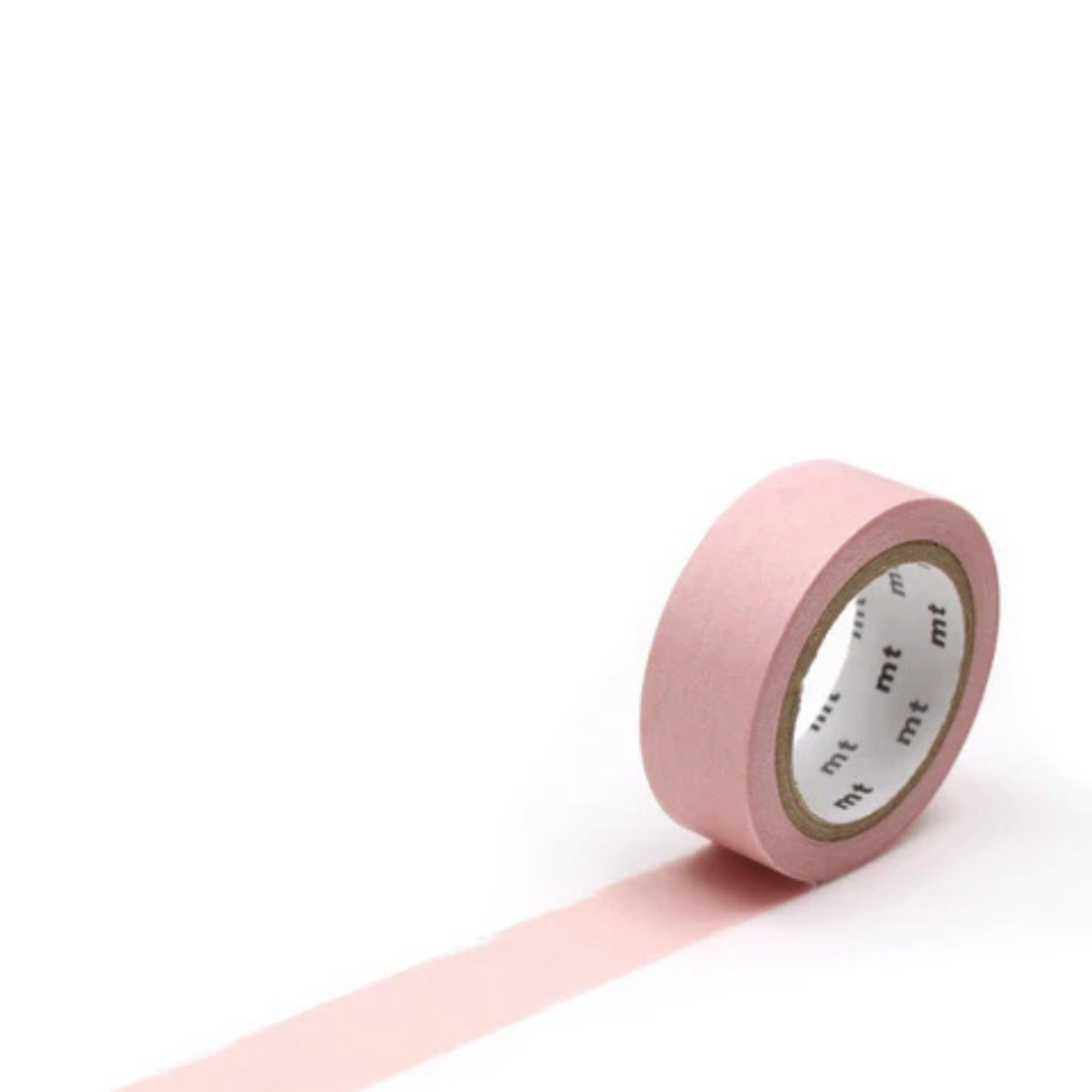 Single roll of pastel pink masking tape against a white background.