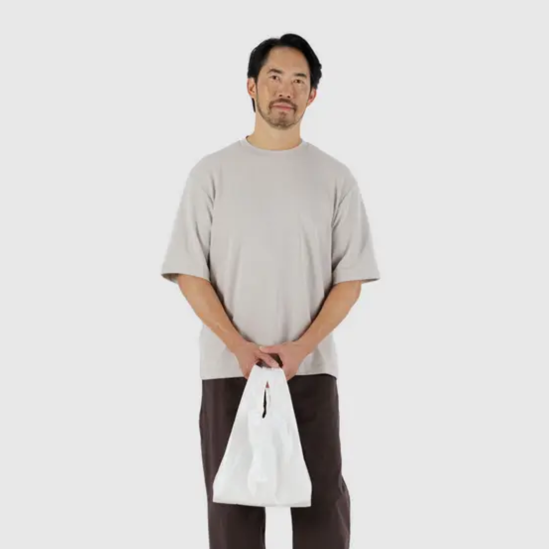 Model holding the small shopping bag
