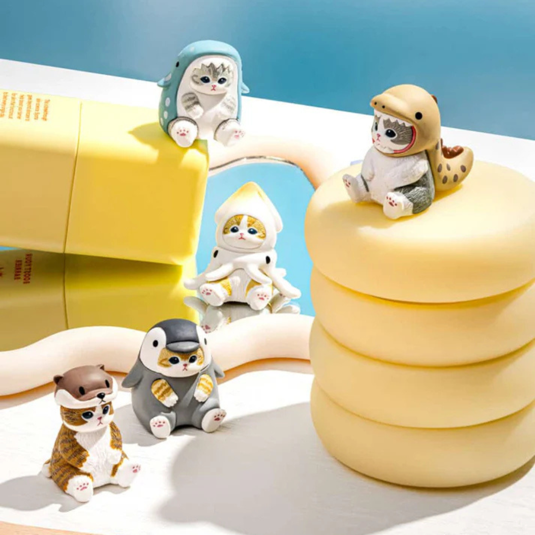 Cute little cats dressed like marine animals sit on a variety of yellow containers