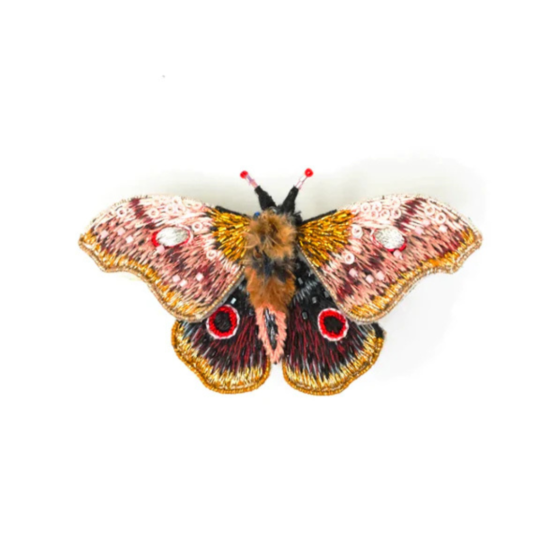 Hand embroidered and beaded moth brooch. This little cutie has a very fluffy body and adorable beaded antenna with little red beads at the tip. His wings are in shades of brown and gold with white and black accents with two big red and black "eyes" at the bottom. The wings are adorned with white, pink, and black beads and micro sequins.