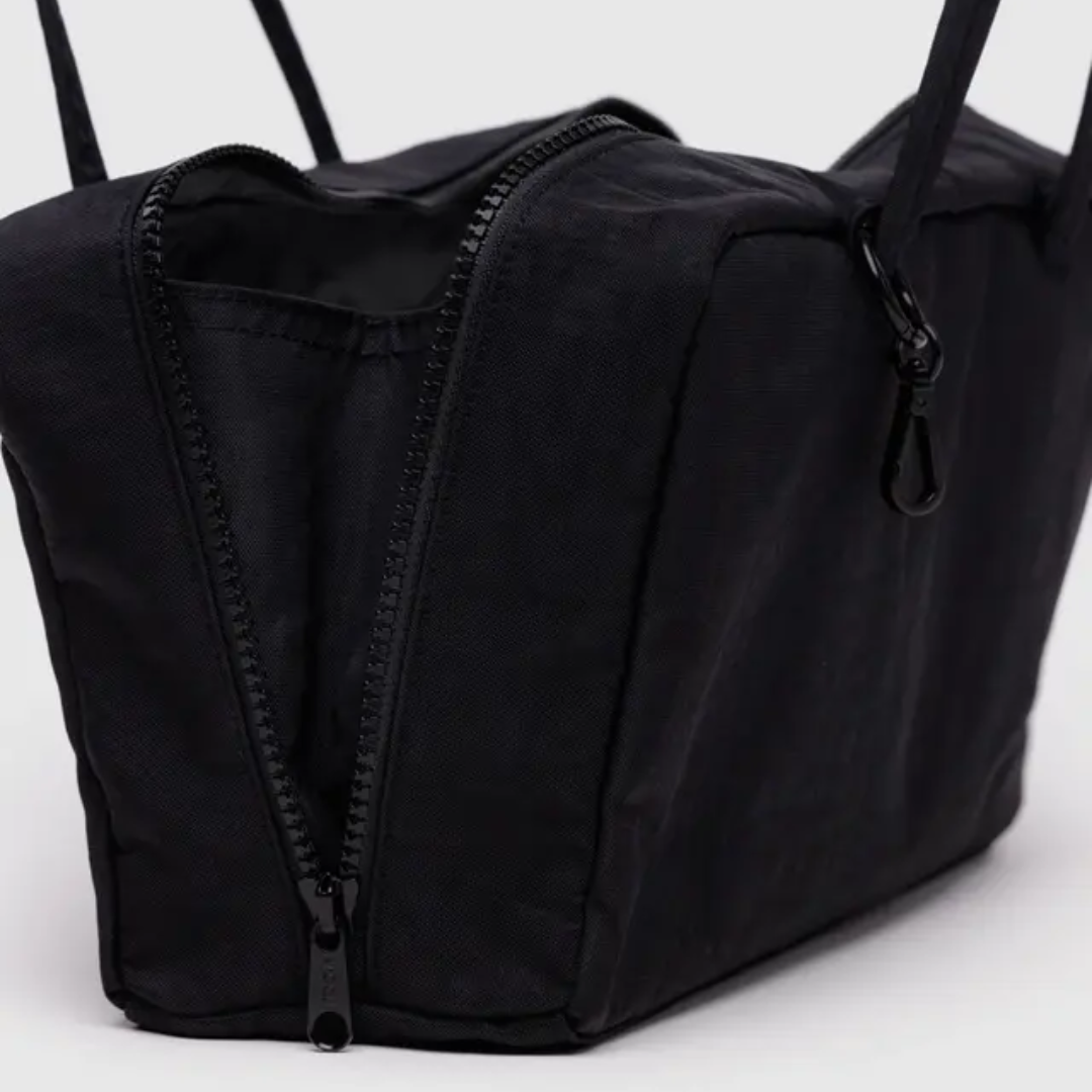 Detail of open bag shows a side gusset inside the zipper to maximize storage.