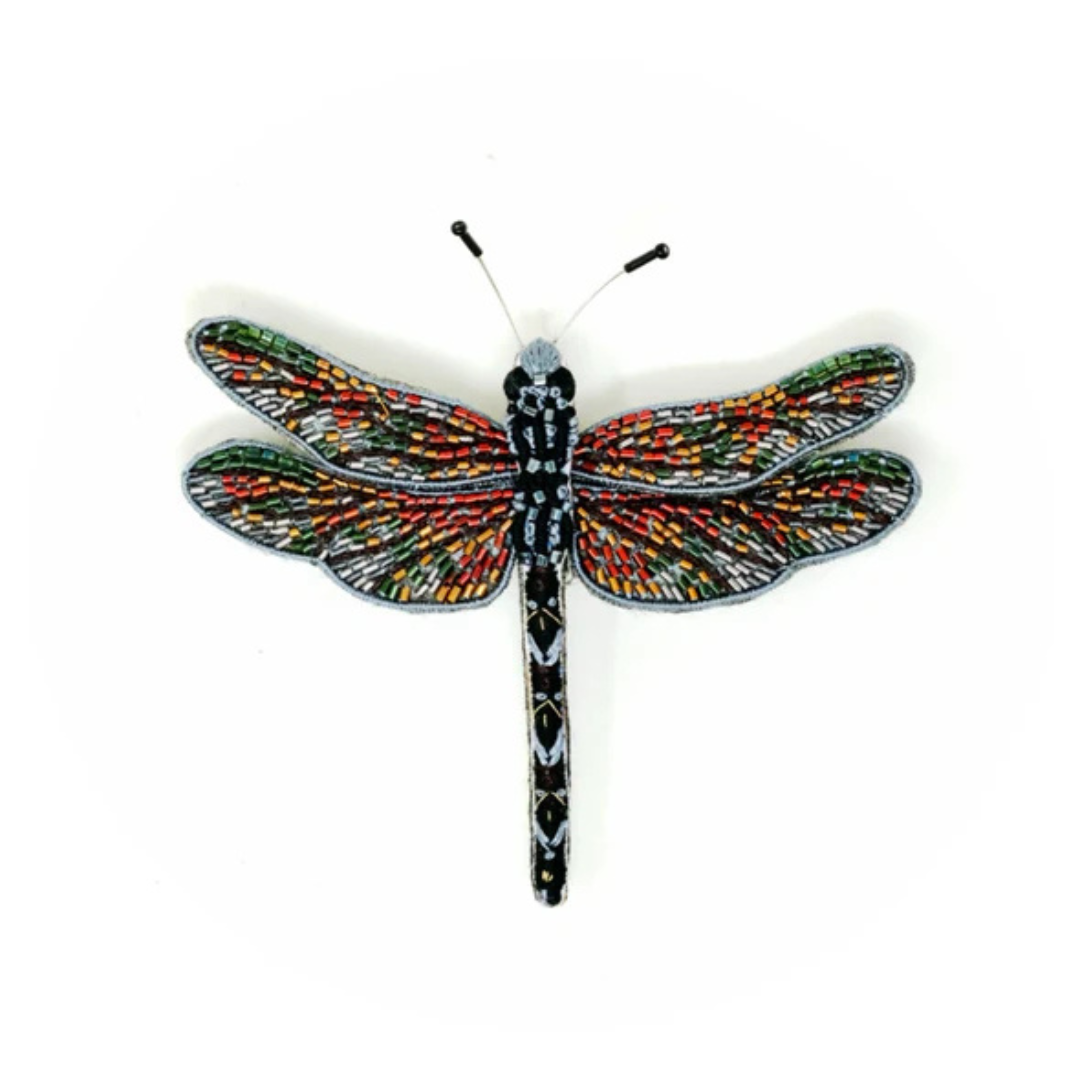 Hand embroidered and beaded dragon fly brooch. The wings are silver, green, gold, and red accented with beads. The body is beaded in sliver and black with white accent stitching.