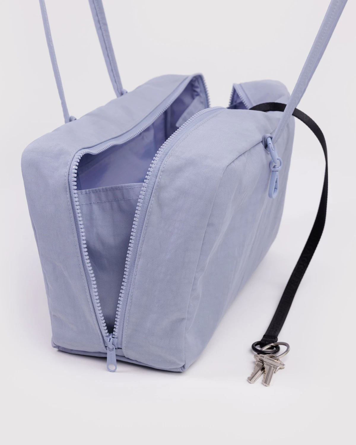 Light blue backpack with a key on a white background