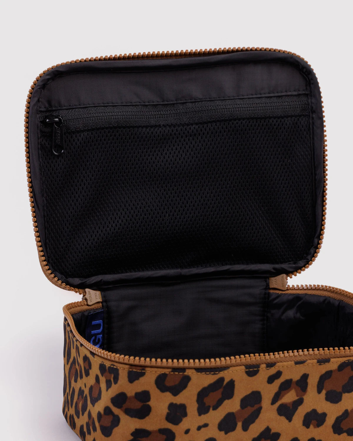 Leopard print makeup bag with black interior on a white background