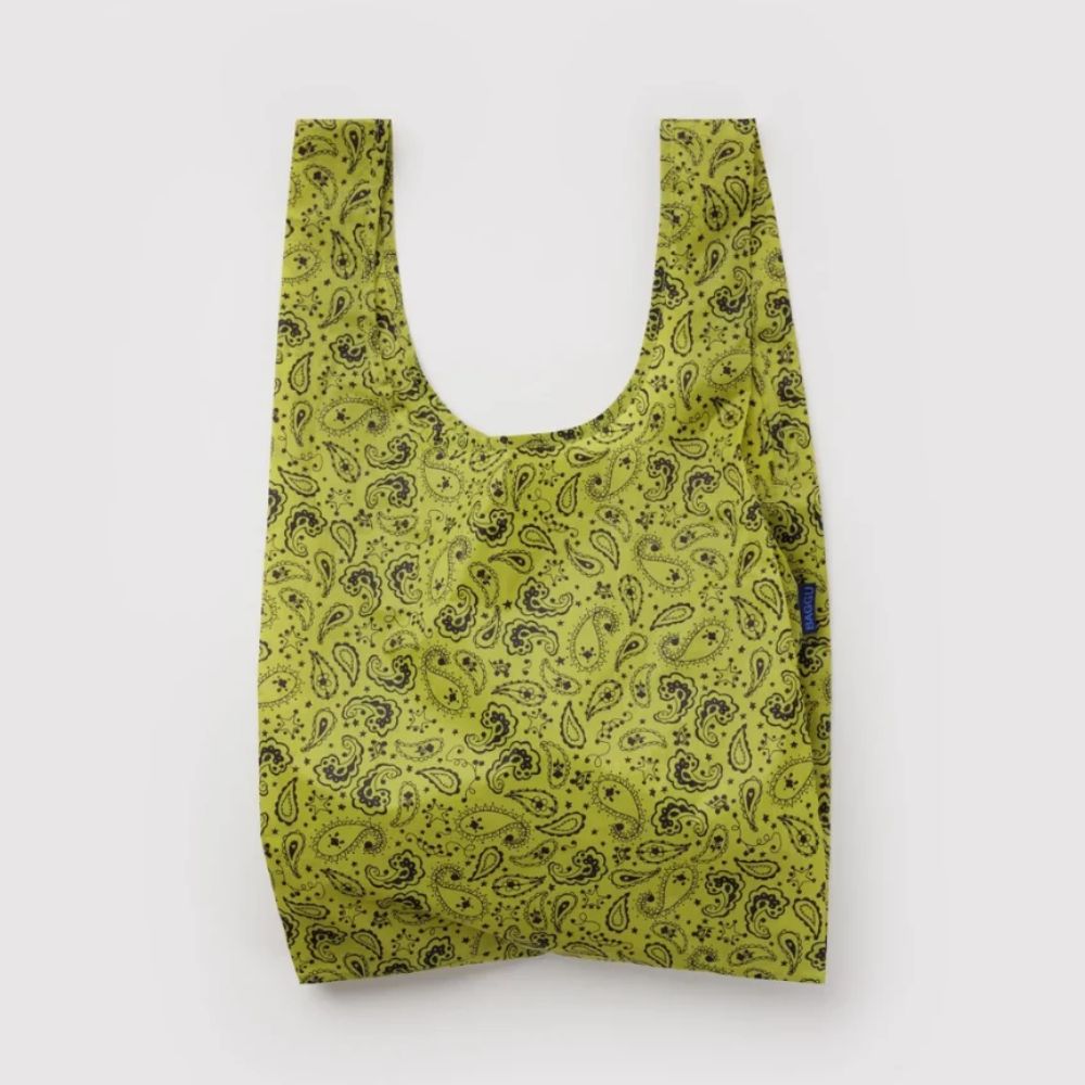 A reusable plastic bag with a yellow-green and black paisley pattern, shown against a plain light gray background.
