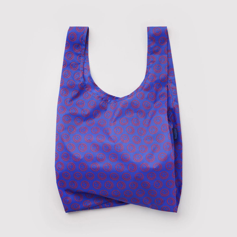 A reusable tote bag with a blue and red repeating circular pattern, photographed flat against a light gray background.
