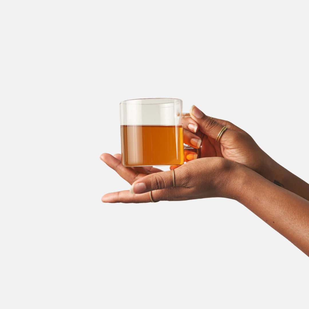 hands holding a cup of tea