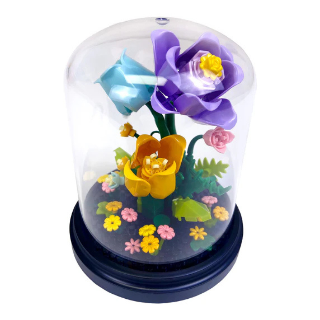 Colorful toy block flowers inside a transparent dome on a white background