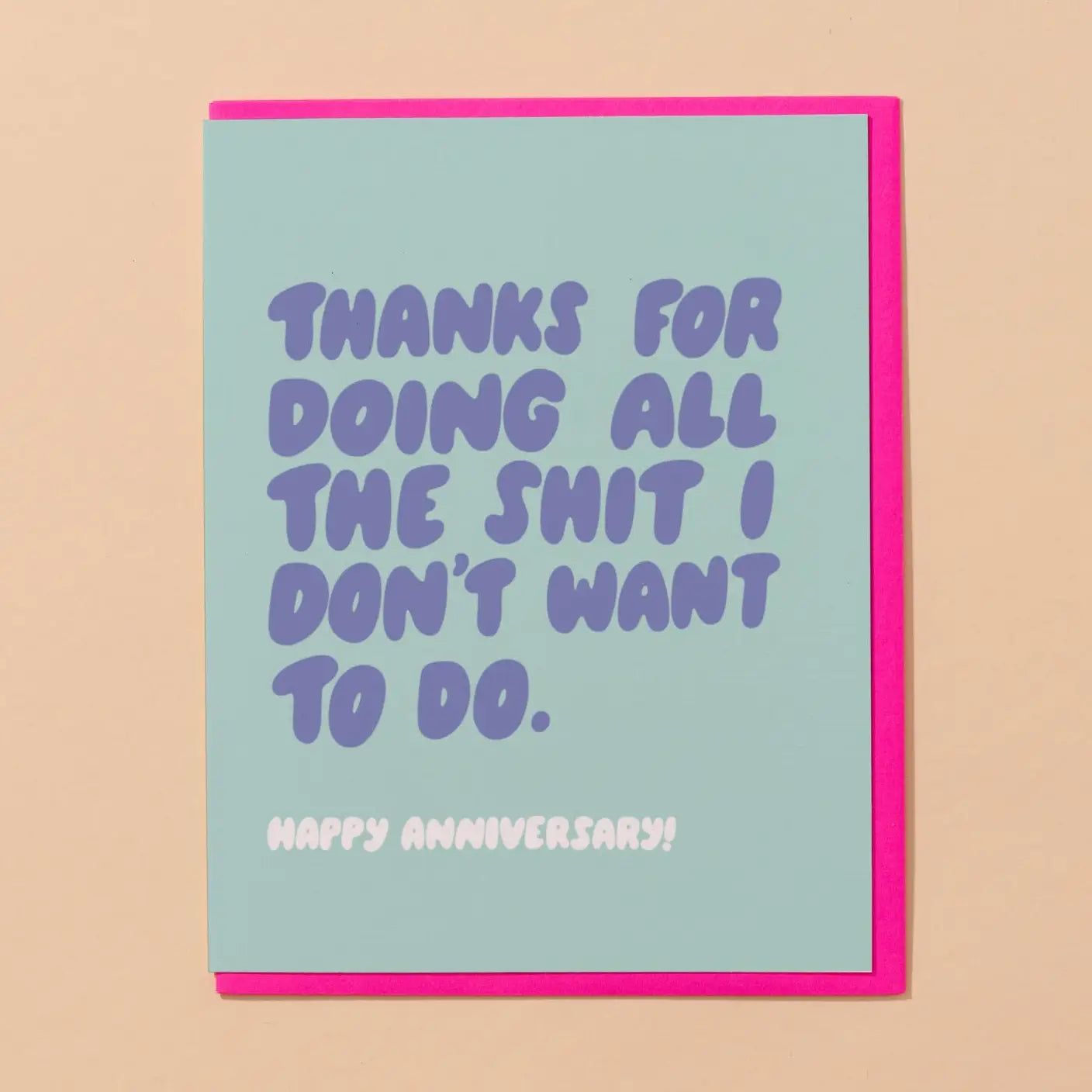Card with humorous anniversary message on a light blue background with pink envelope