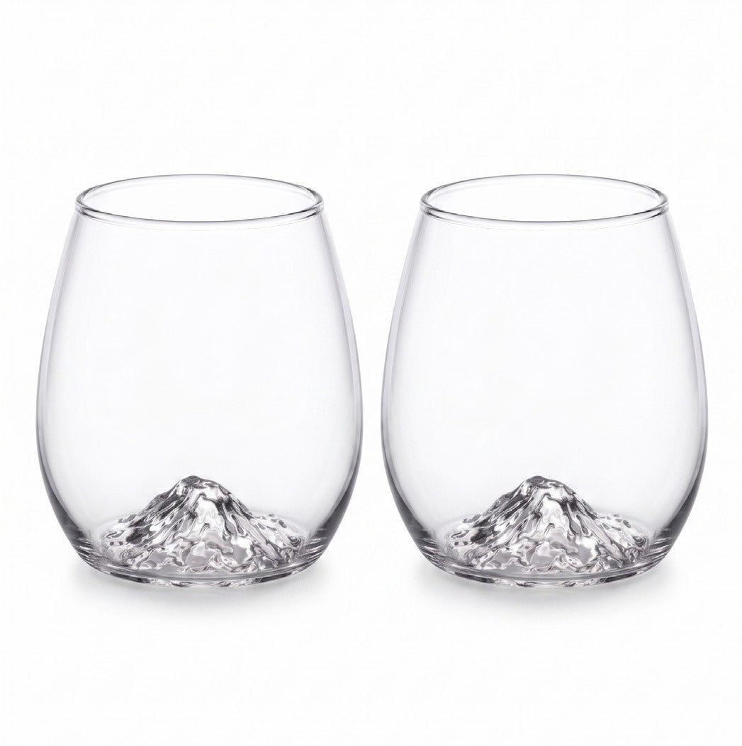 Two clear stemless wine glasses with a sculpted mountain design at the base, shown side by side on a white background.