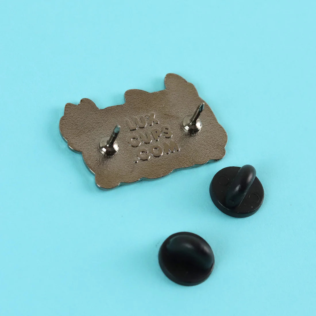 Back has 2 pins and the LuxCups logo with rubber pin backs