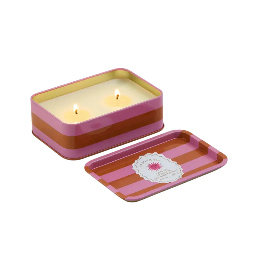 Tin open to show lit candle with wicks, tin top is fully removed