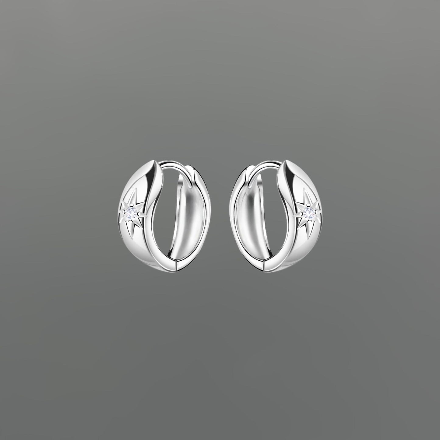 Pair of silver hoop earrings with star sparkle on a gray background