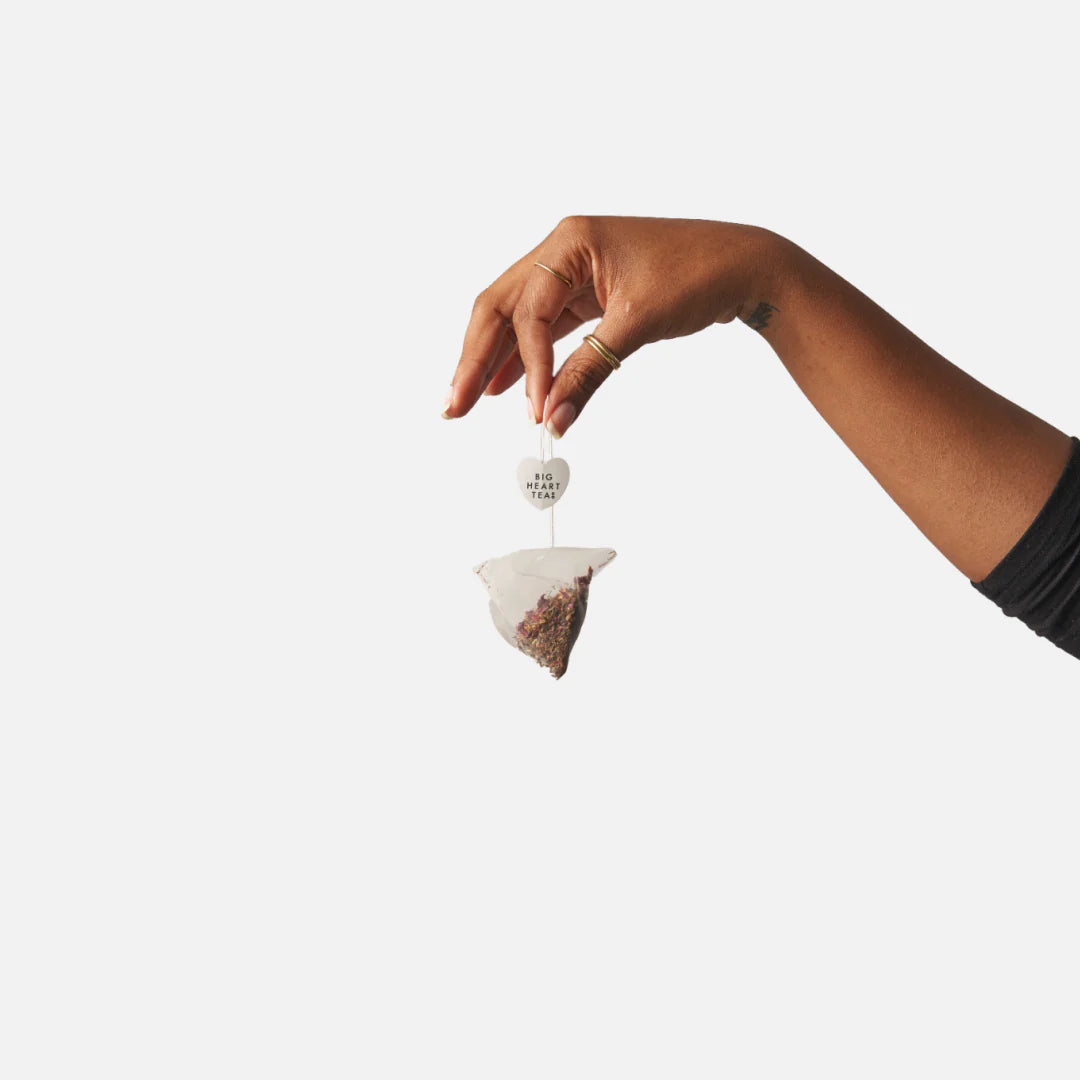 hand holding a teabag by the string