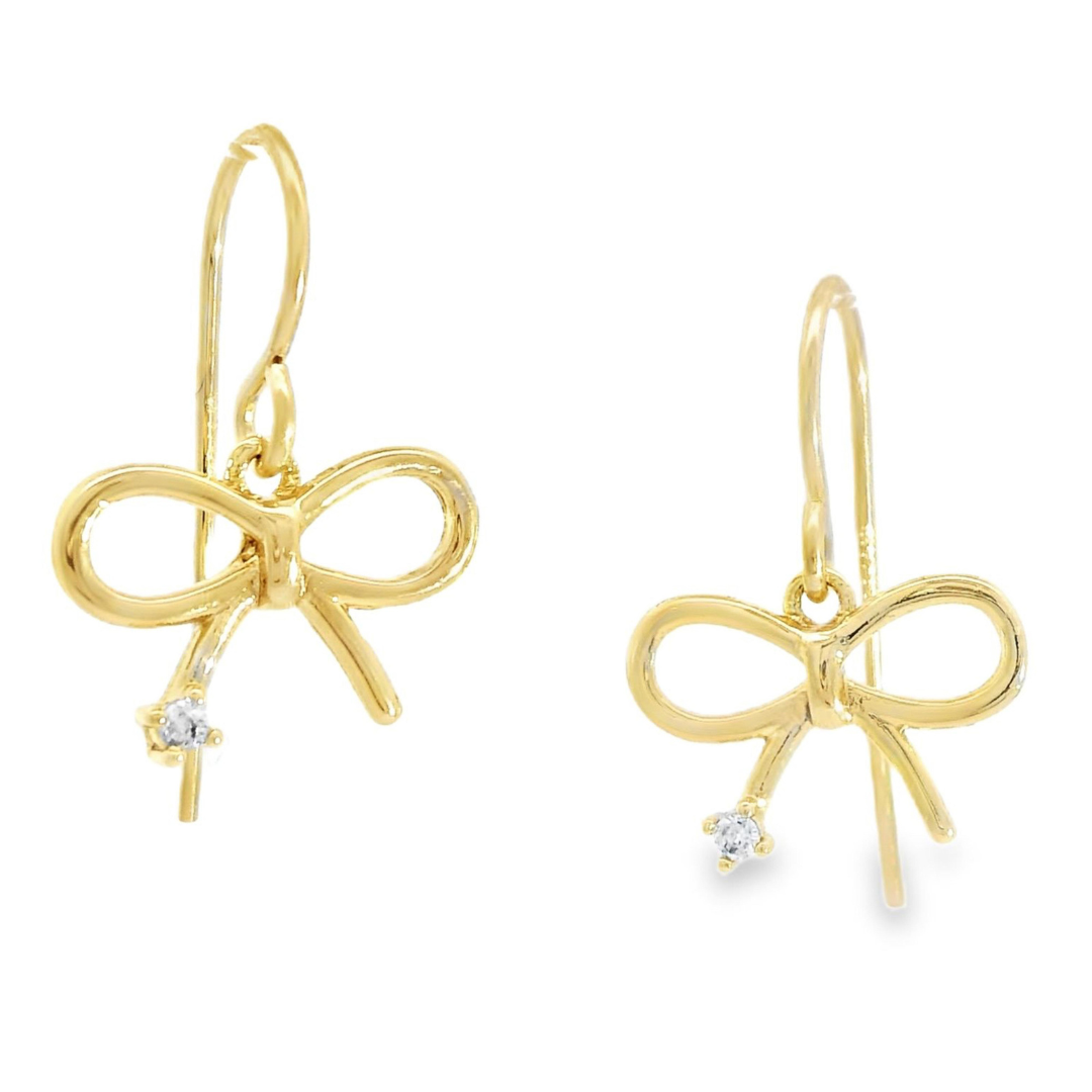 Gold bow shaped earrings featuring a cubic zirconia stone at the bottom of each earring.