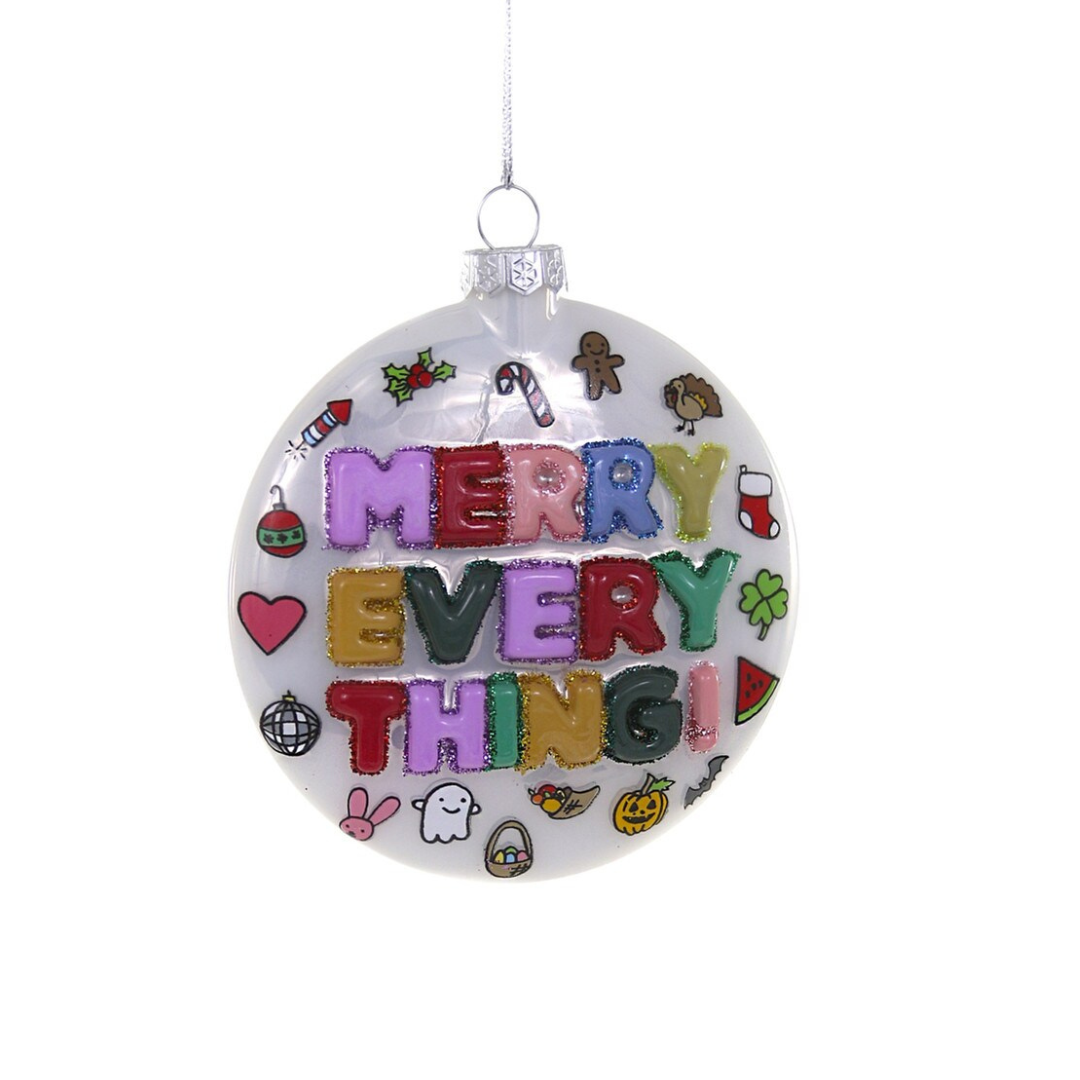 White glass ornament that says "Merry Everything!" and is decorated for many different holidays