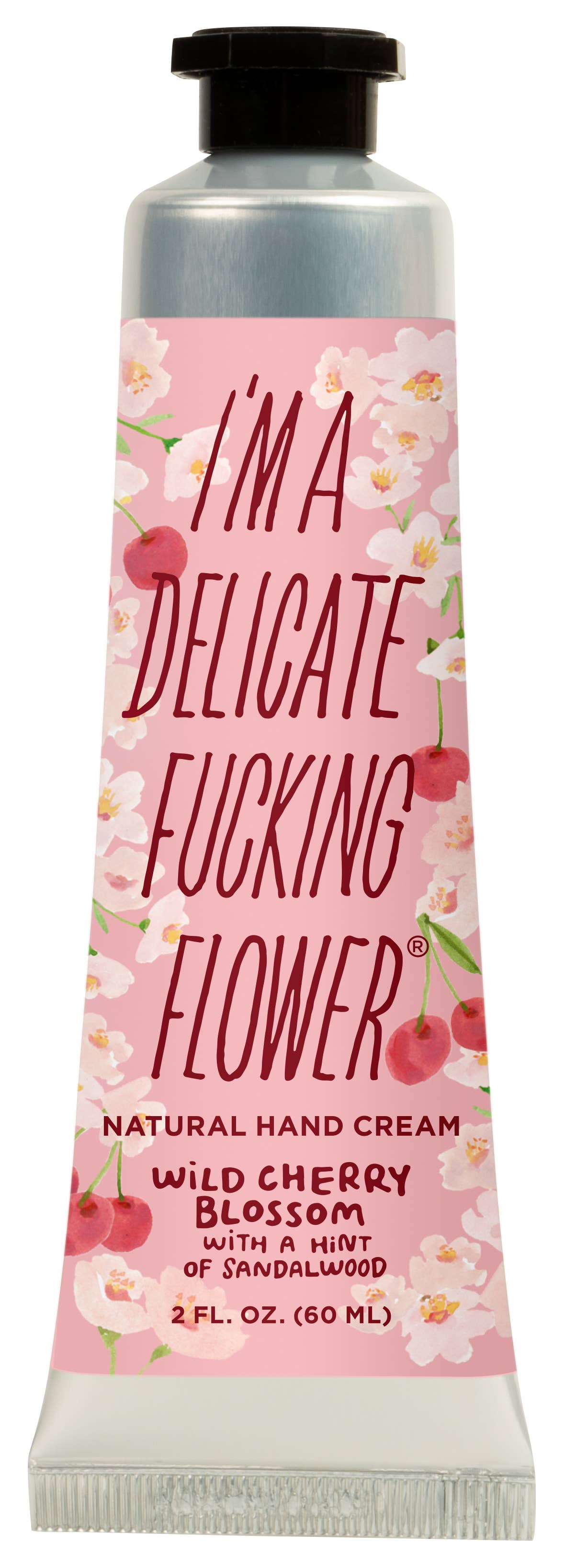 A squeeze tube of hand cream with a pink cherry blossom label and a black cap, shown on a plain white background. The label reads 'I'M A DELICATE FUCKING FLOWER' and 'WILD CHERRY BLOSSOM'.