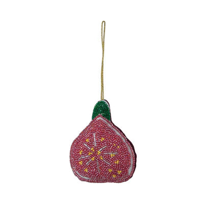 Beaded fabric ornament decorated to look like a fig sliced in half, the fig meat rendered in glass seed beads. Ornament hangs from a gold cord.