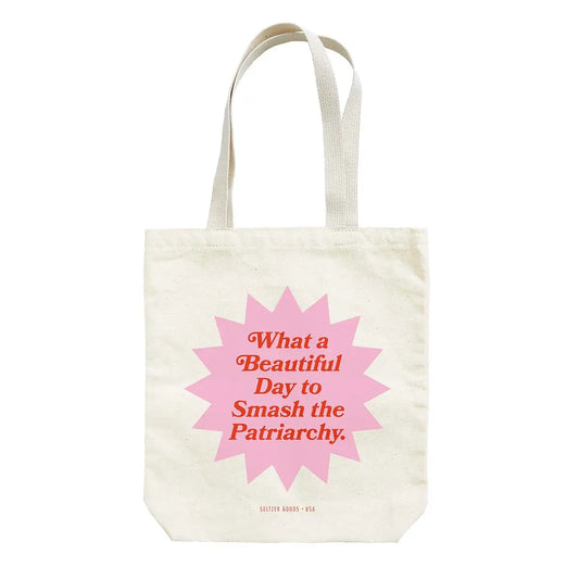 canvas tote bag says what a beautiful day to smash the patriarchy in red text over a pink background