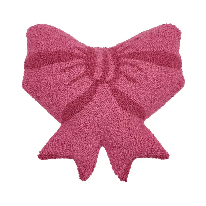 Bow shaped hook wool pillow has a boucle texture. It is very pink.