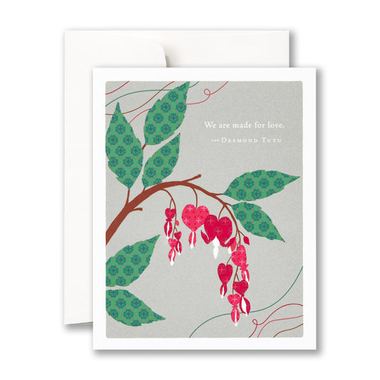Card with heart shaped red flowers on a branch with patterned leaves against a gray background. Says "We are made for love - Desmond Tutu"