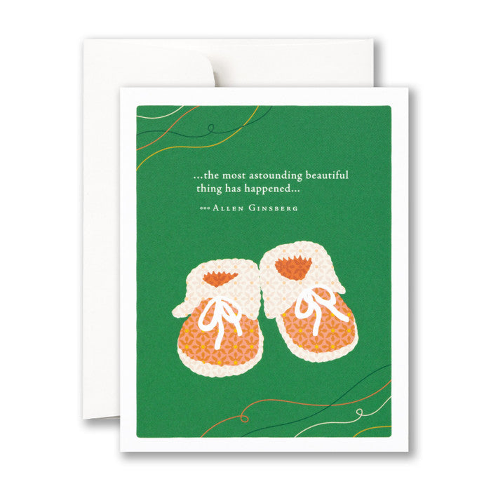 Card with baby shoes on a green background reads " the most astounding beautiful thing has happened... - Allen Ginsberg