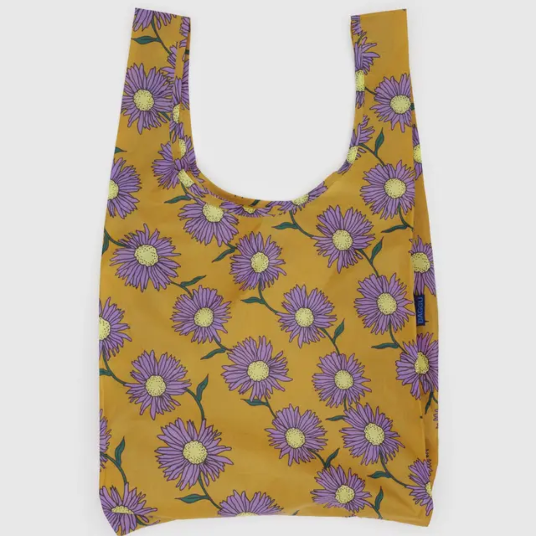 Yellow shopping bag covered in a daisy print