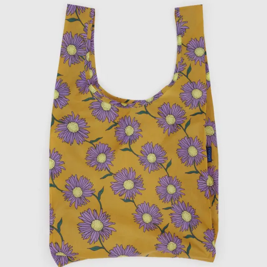 Yellow shopping bag covered in a daisy print