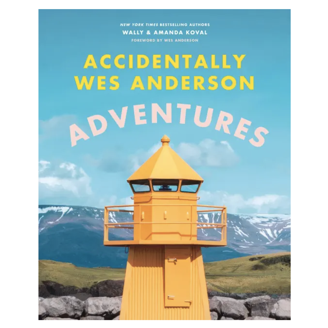 Book cover of 'Accidentally Wes Anderson Adventures' with a yellow lighthouse against a blue sky.
