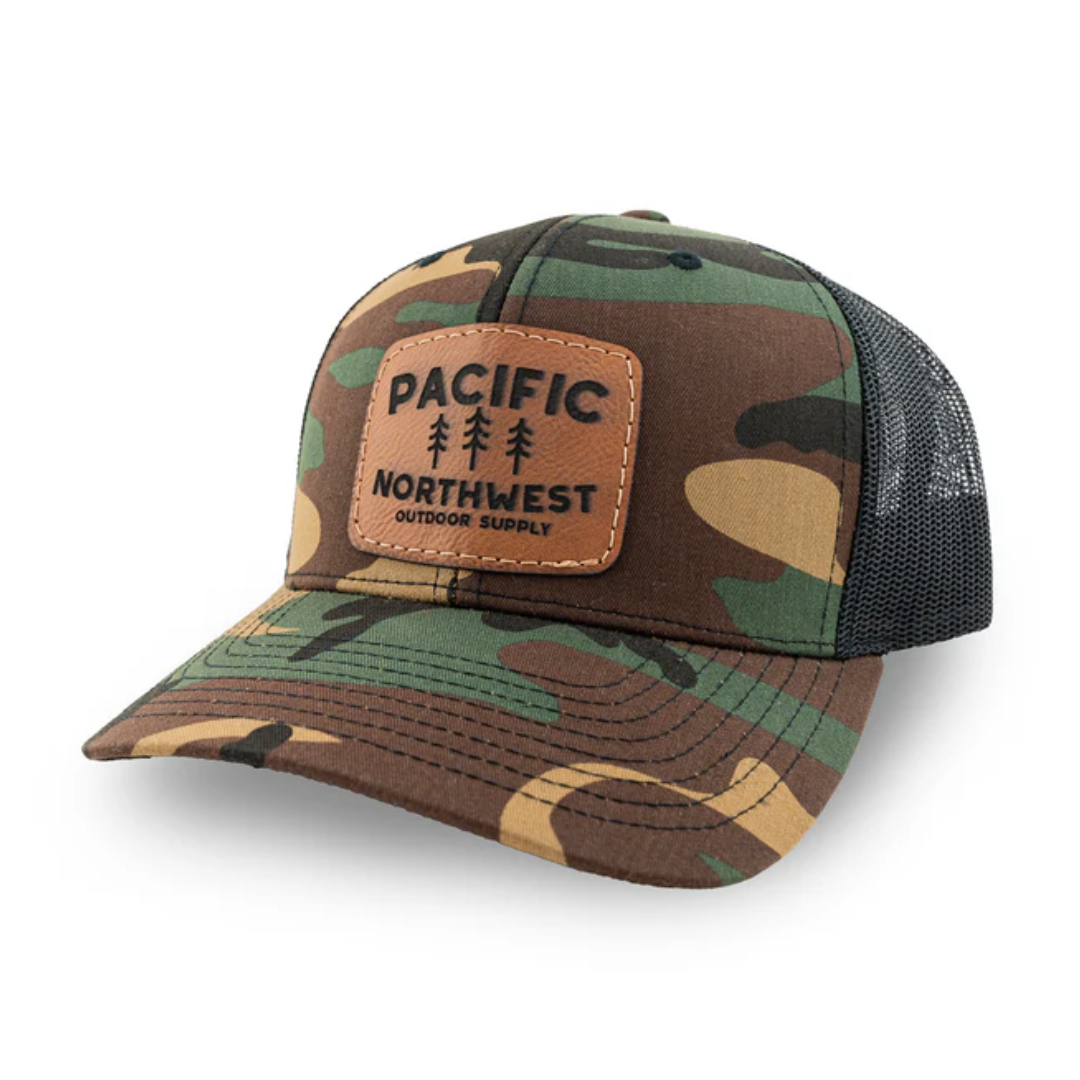 Camo print trucker cap with leather-like patch that says "Pacific Northwest