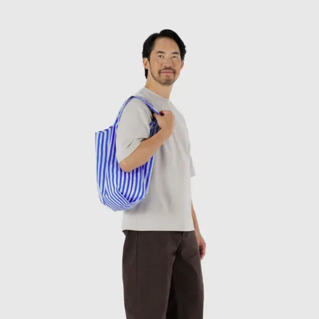 Model holding the standard Baggu shipping bag