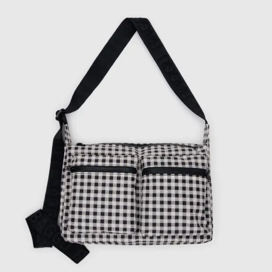 Messenger style bag in black and white gingham with two zip cargo pockets at the front