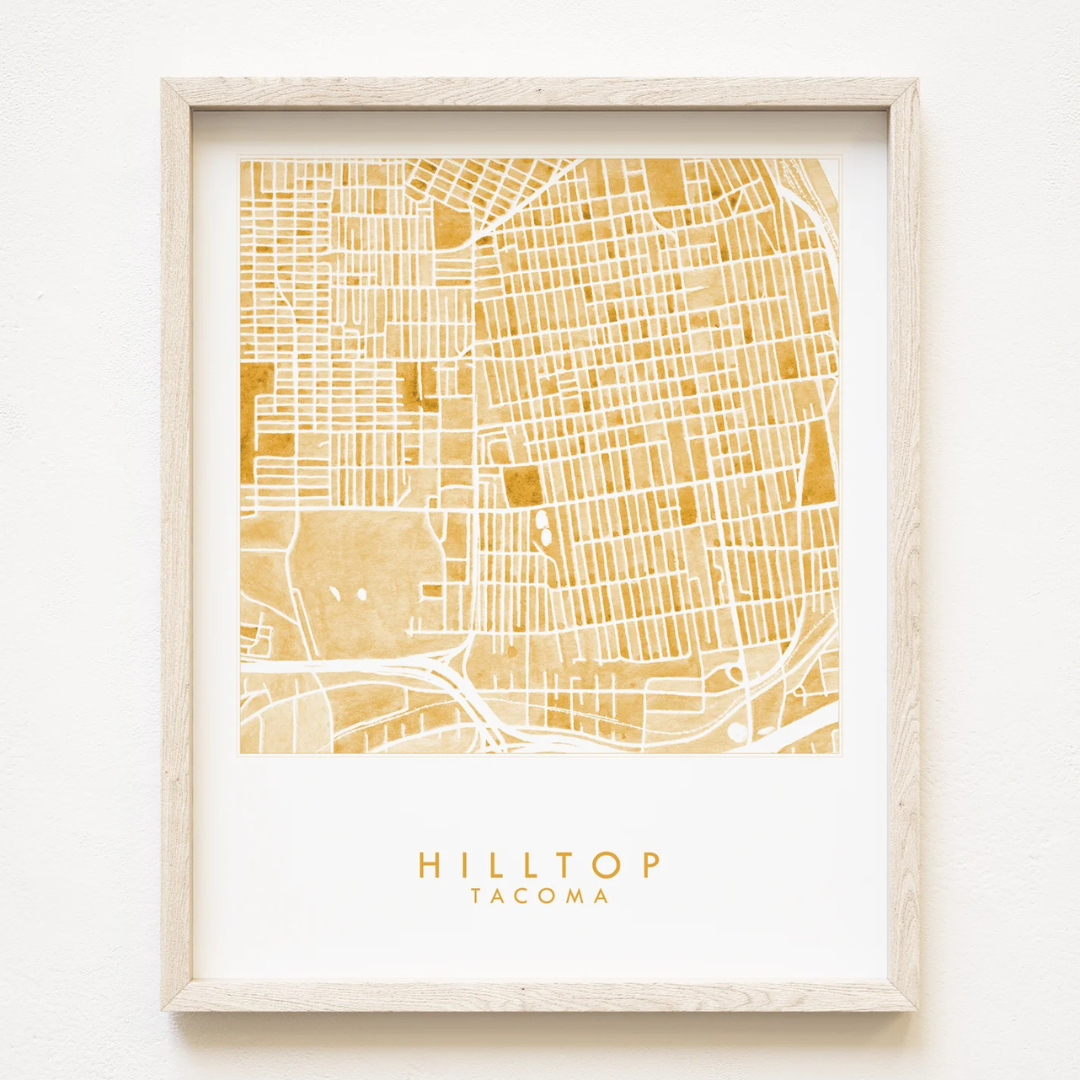 Tacoma neighborhood map of the hilltop area printed in yellow/orange featuring the words "HILLTOP TACOMA" underneath it.