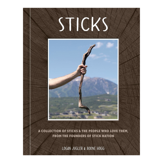 Cover of "Sticks: A Collection of Sticks & the People Who Love Them, From the Founders of Stick Nation" is rown and features an arm with a fist grasping a really cool looking stick