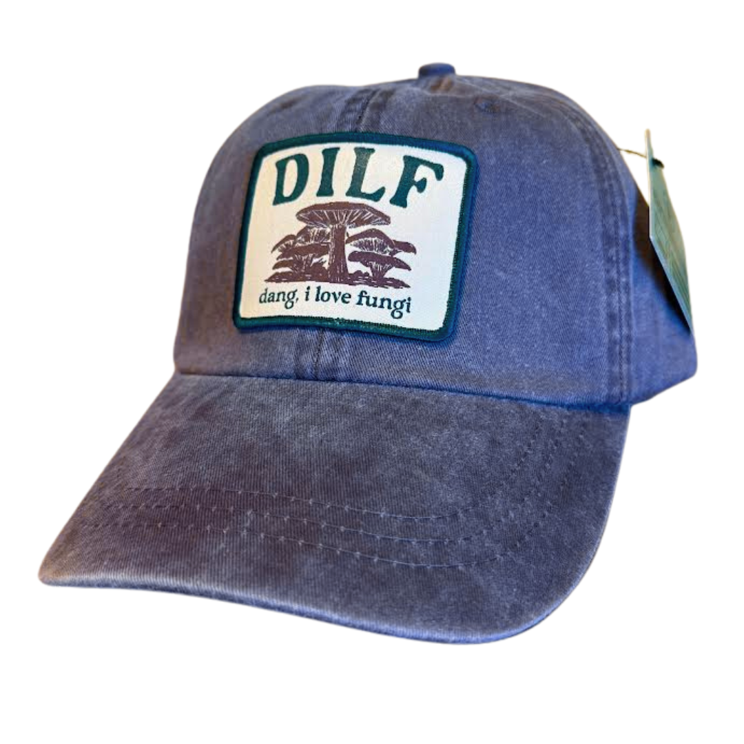 Soft brown baseball style cap with a patch on the front. Patch is brown and green with an image of mushrooms and says "DILF - dang, i love fungi"