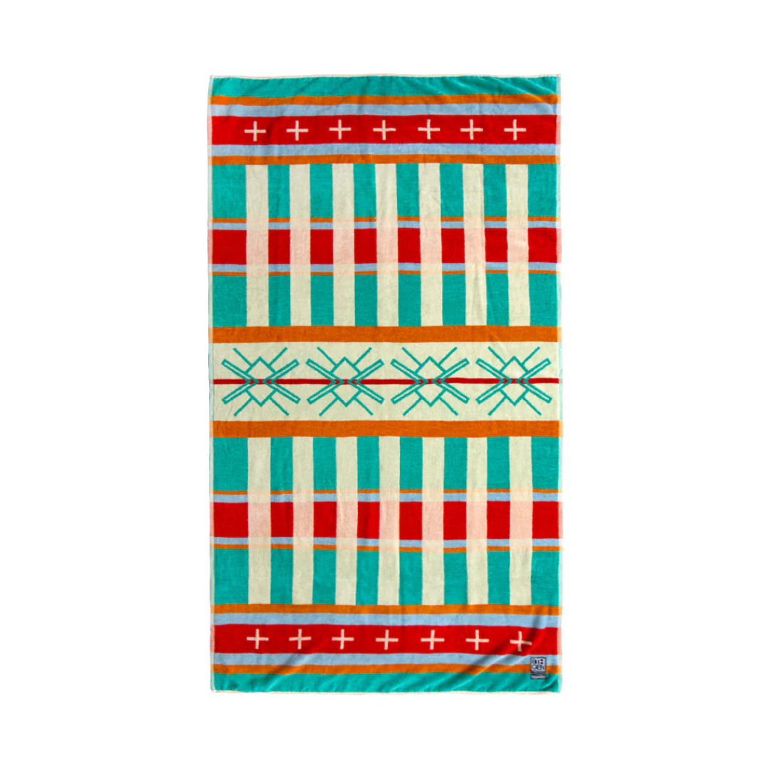 Tribal patterned beach towel featuring striping and cross pattern in hues of red, orange, yellow, green and blue.